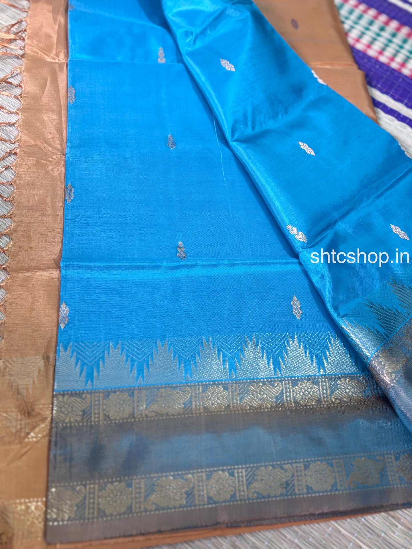 Turquoise Blue Banana Silk Saree with Copper Brown Contrast Pallu, Woven Buttas and Contrast Blouse  Description
